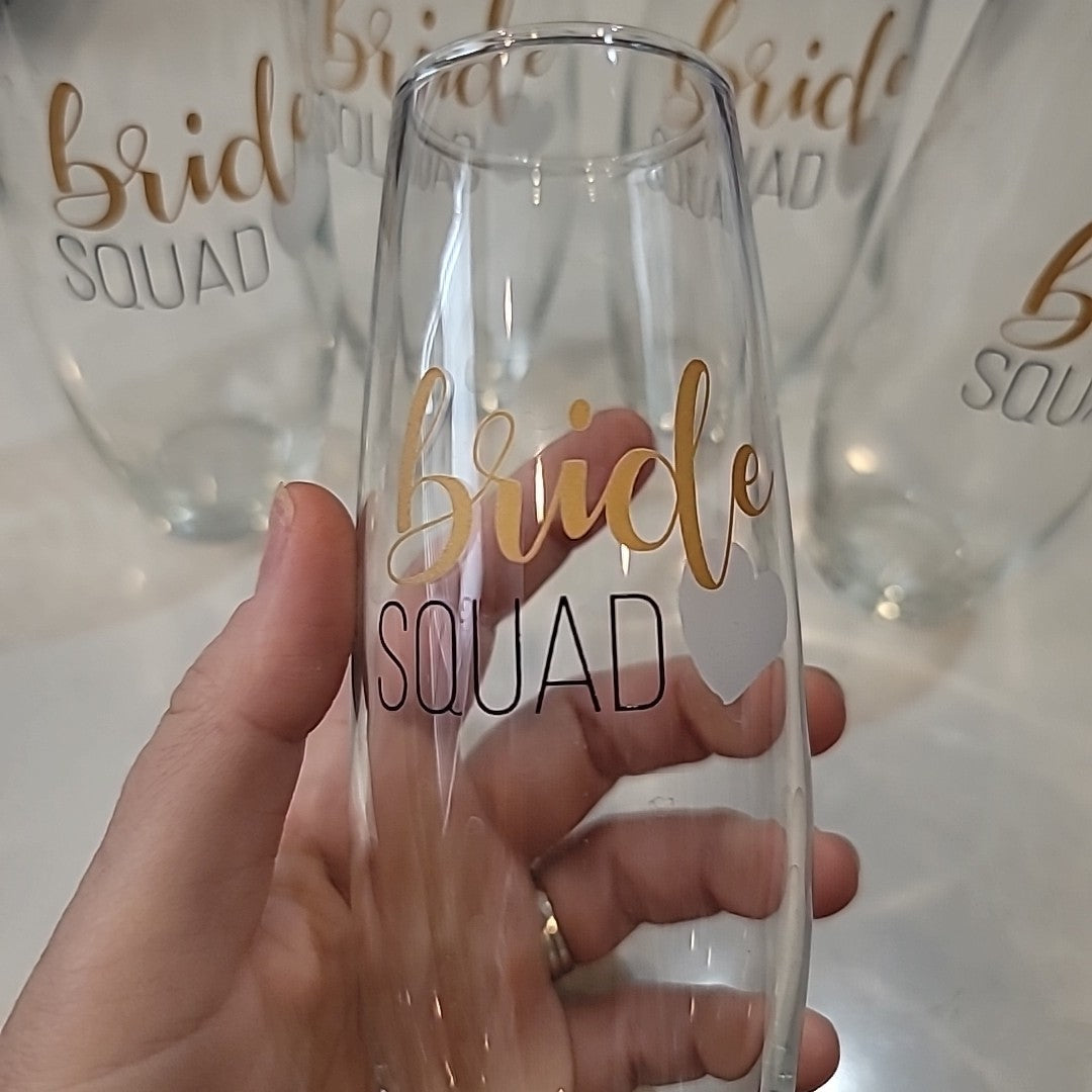 Set of 5 BRIDE SQUAD Champagne flutes. Gold and black letters with white heart