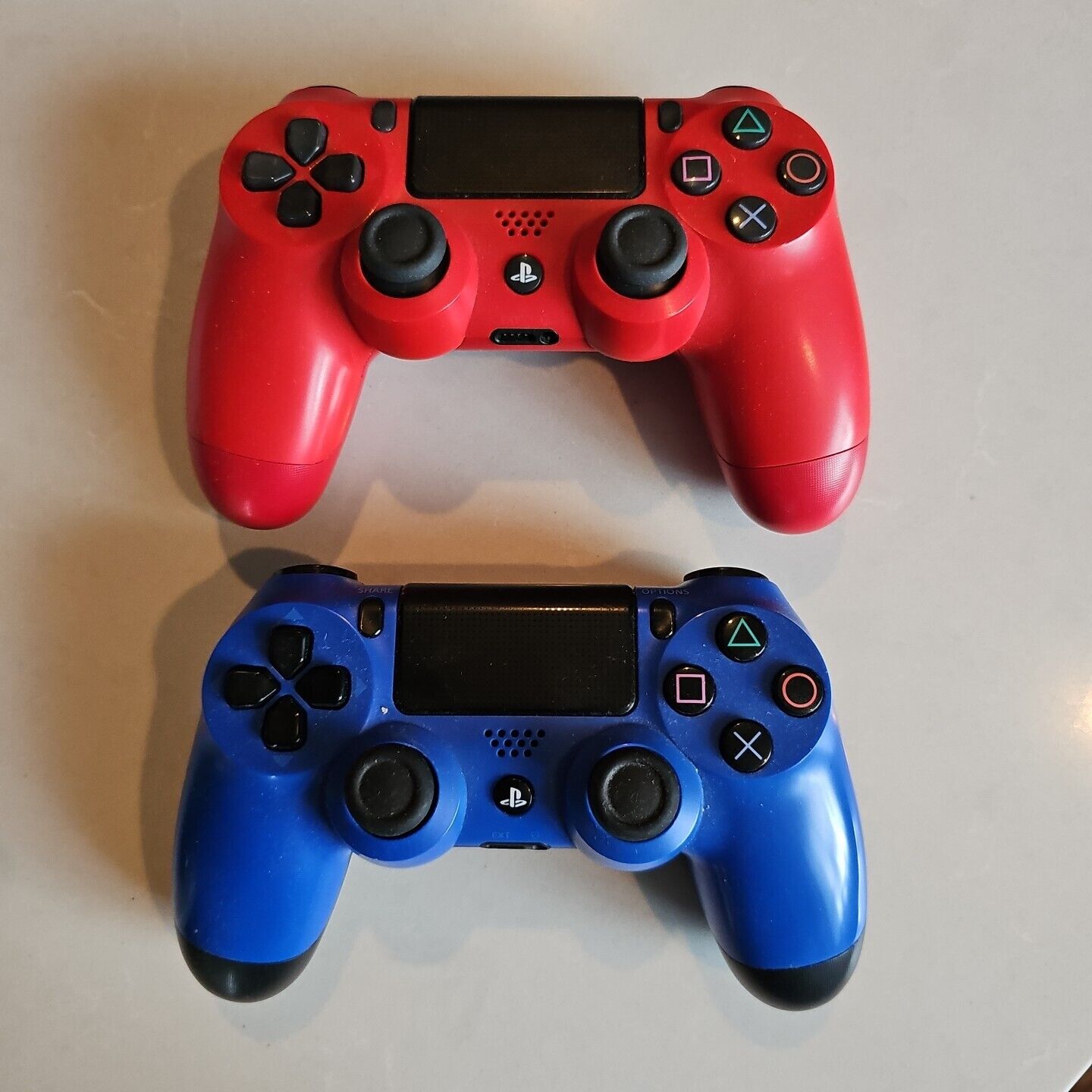 2 Sony PS4 Dualshock Wireless controllers, 1 blue 1 red 