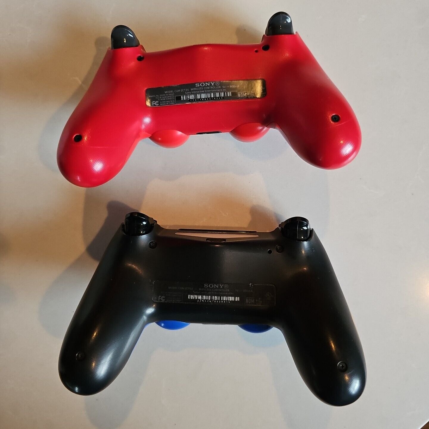 2 Sony PS4 Dualshock Wireless controllers, 1 blue 1 red 